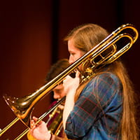 a girl playing on the trumpet