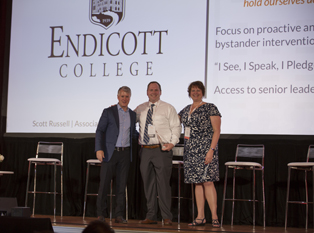 Endicott College accepts award on stage