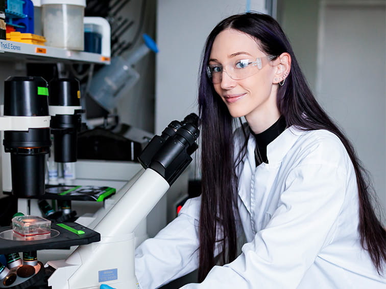 Student in lab with a microscope