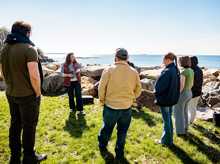Students in an outdoor class by the ocean