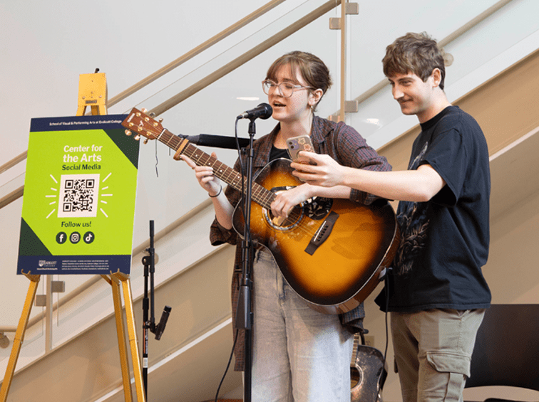 Student playing a guitar